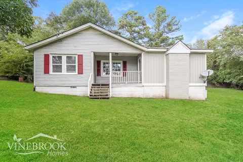 A Vinebrook Homes house with a red door and white siding.