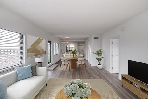 a living room and dining room with a table and chairs
