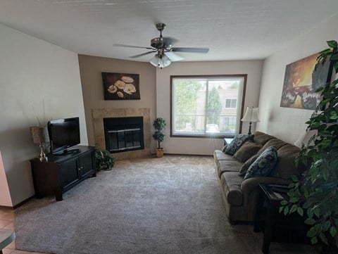 a living room with a couch and a ceiling fan