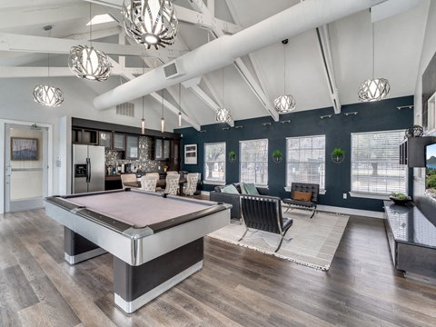 clubhouse with pool table at the district flats apartments in lenexa  at Vibe on Riverside, Austin, Texas