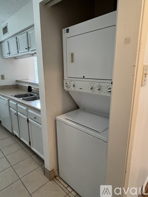A white oven with a door open is in a kitchen.