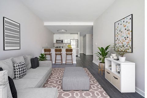 a living room with a couch and a kitchen in the background
