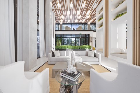a living room with white furniture and a large window