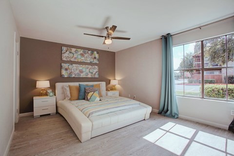 a bedroom with a bed and a ceiling fan