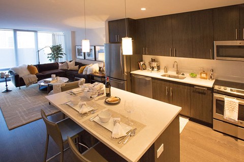 a kitchen and living room with a table