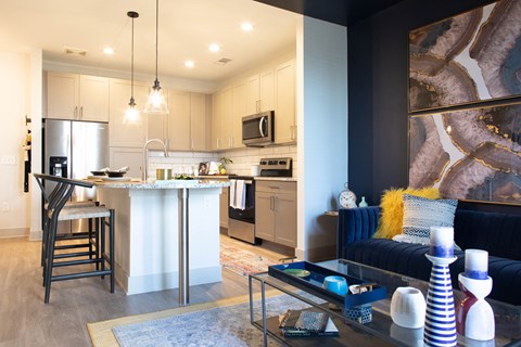 a living room with a kitchen and a table