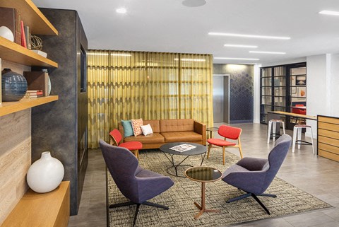 a living room with a couch and chairs and a table