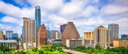 Downtown Austin skyline with high-rise buildings, highlighting areas where luxury apartments can be rented for less.
