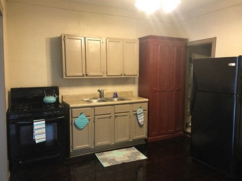 a small kitchen with a sink and a refrigerator