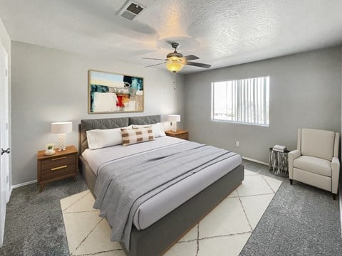 A bedroom with a large bed and a ceiling fan.
