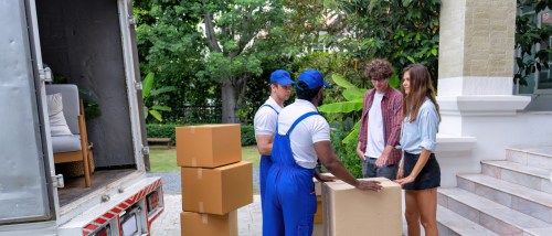 A Gen Z couple talking to movers after signing their lease for a rental apartment.