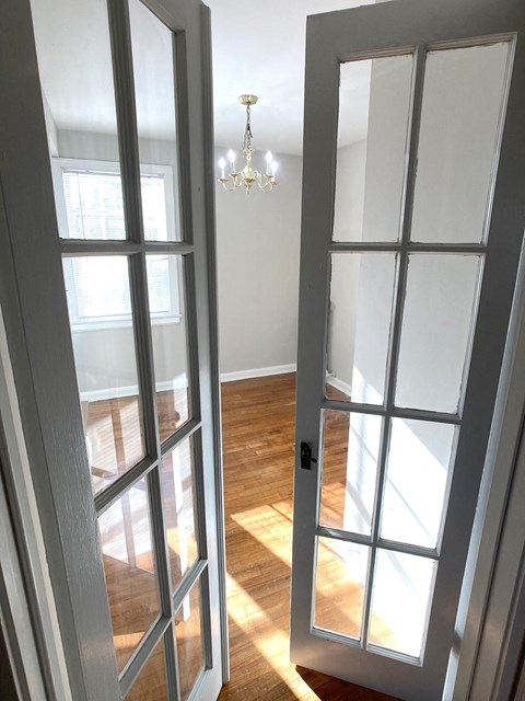 a living room doors and a chandelier