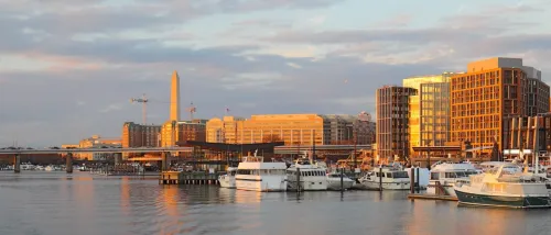 A waterfront view of Washington, D.C. underneath an overcast sky, as seen from the Wharf.