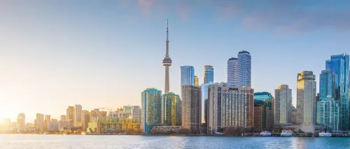 Toronto skyline at sunrise, featuring the iconic CN Tower and modern high-rises, highlighting the city’s status as a major renter hub in Canada.