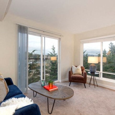 a living room with a couch and a chair and a table