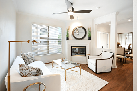 a living room with a white couch and a fireplace