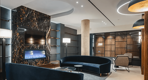 a living room with blue couches and a fireplace